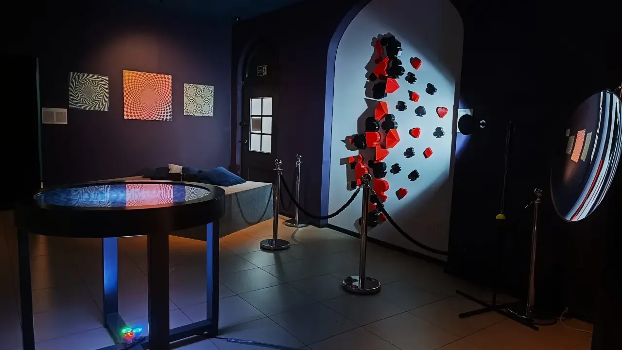 W muzeum iluzji Poznań zobaczysz obrazy optyczne, iluzje 3D z kartami do gry i zakrzywione lustro.
